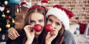 Two women surrounded by Christmas decor
